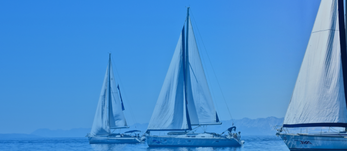 Three yachts sailing on the ocean