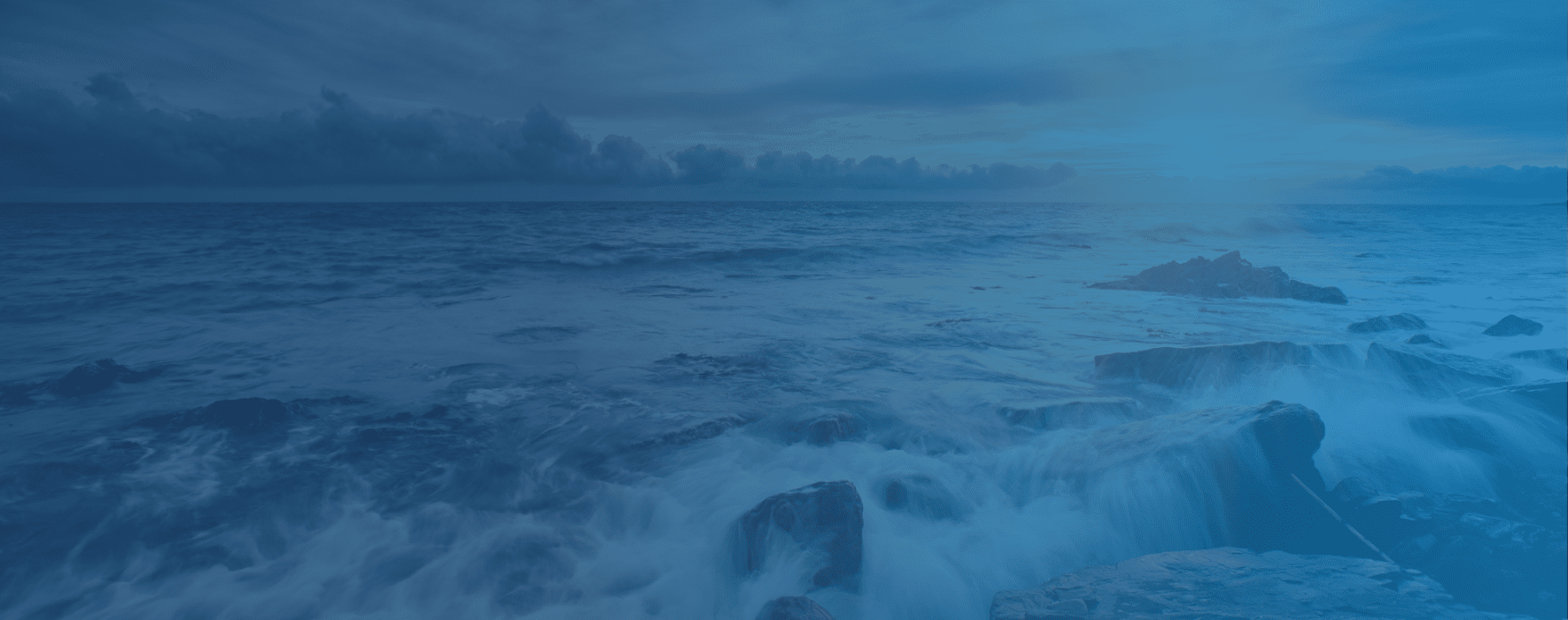 Wave crashing into a rocky shore