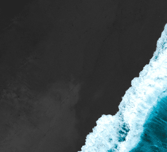 Wave crashing into a dark sandy shore